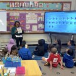 Pamelya speaking with elementary students